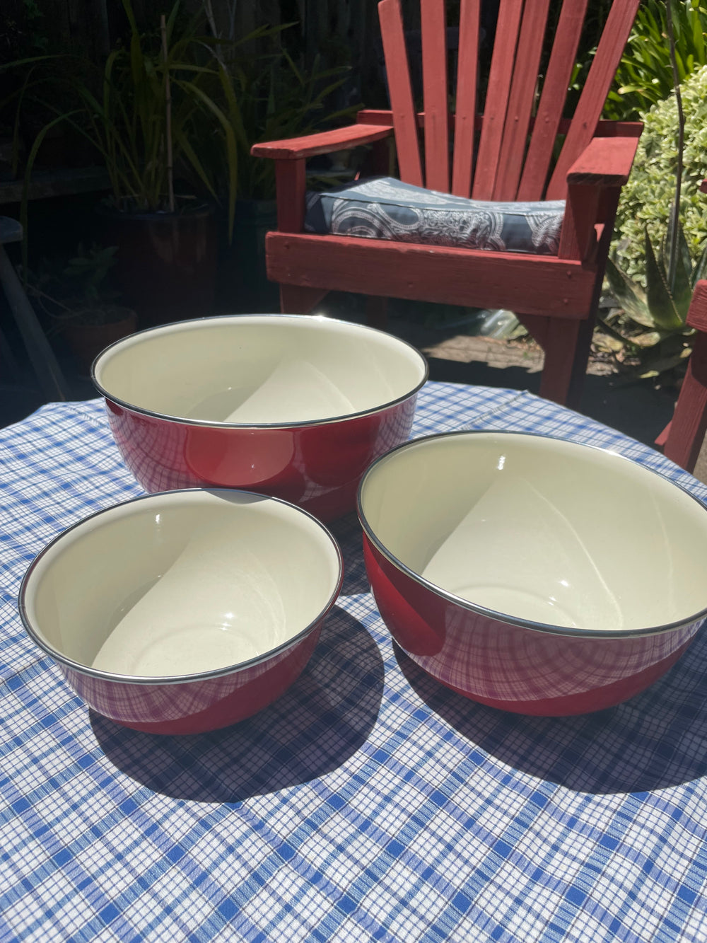 Set of bright red enamel bowls for kitchen decoration and use