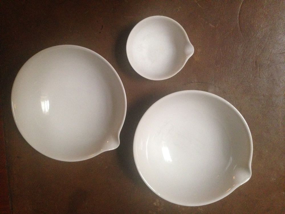 Vintage porcelain chemical bowls with laboratory equipment.