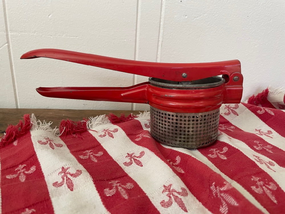 Vintage hand-held juicer on a kitchen counter