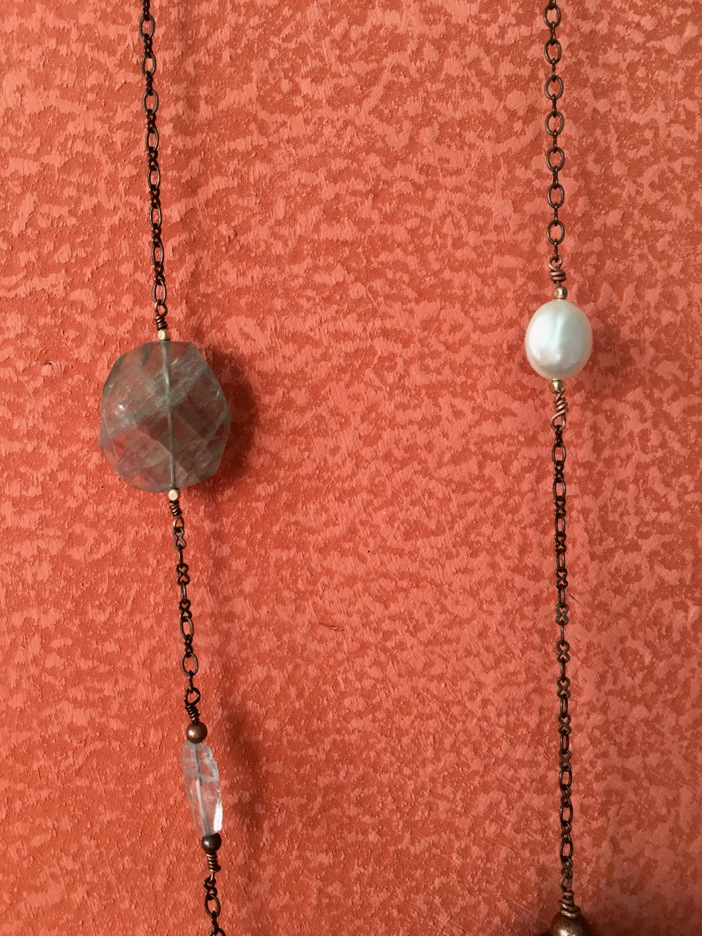 Handmade earth bead necklace on a copper chain with natural stones.