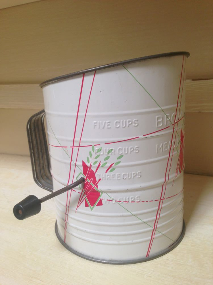 Vintage graphic sifter with retro kitchen decor design.